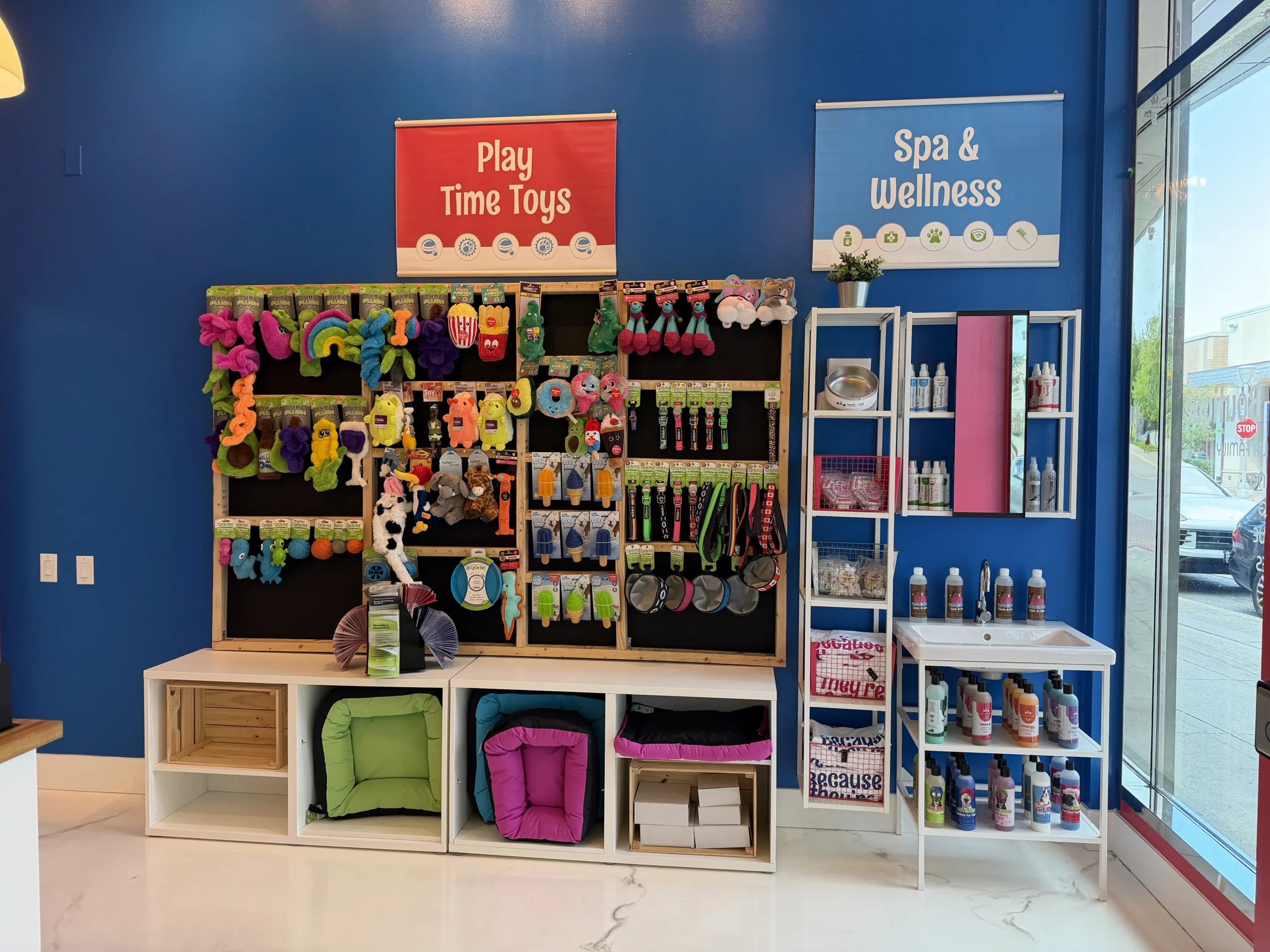 Retail display of dog toys, grooming supplies, and wellness products inside Splash and Dash Groomerie & Boutique.