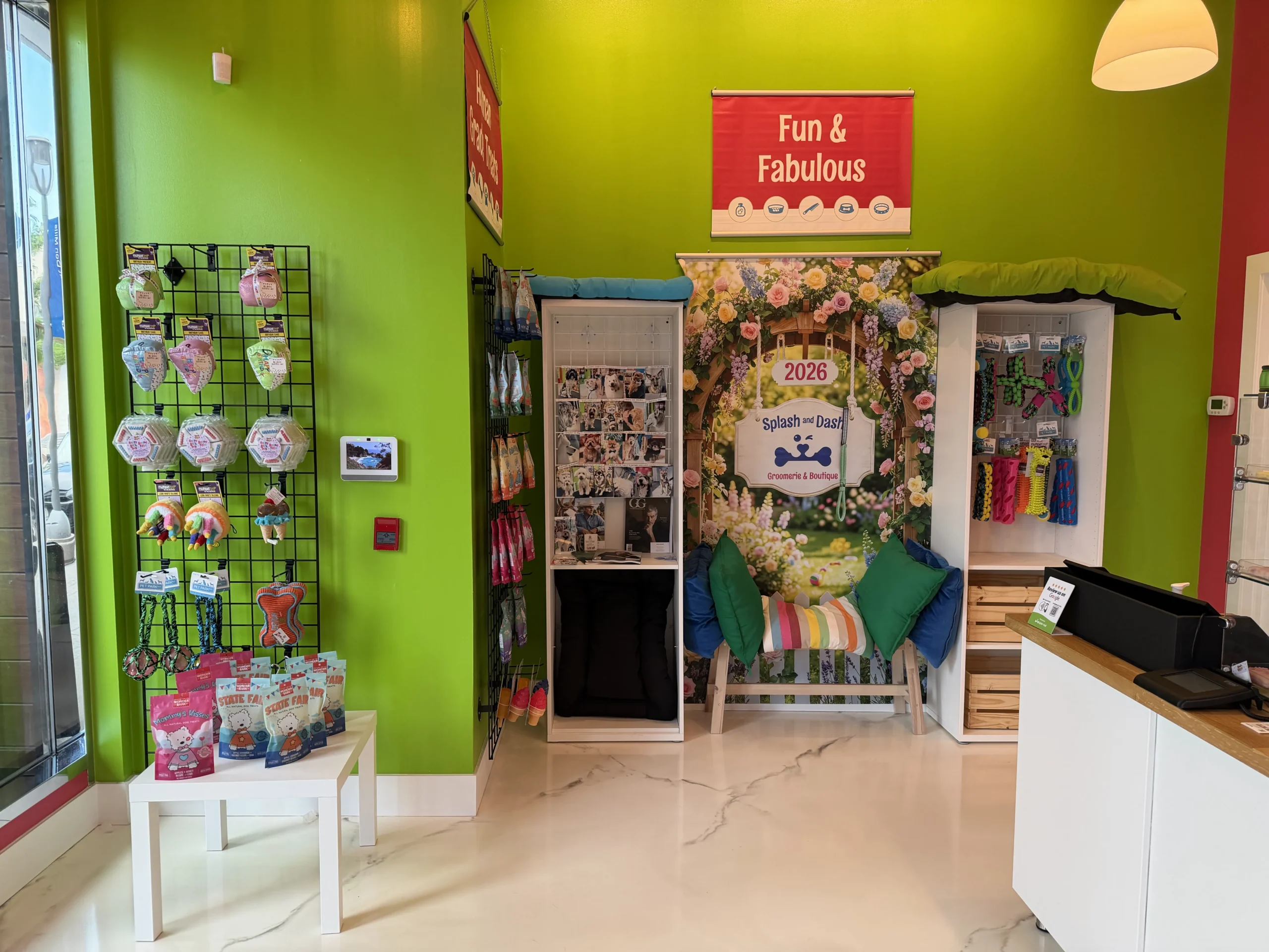 Colorful Splash and Dash Groomerie & Boutique interior featuring pet products and a branded photo backdrop.